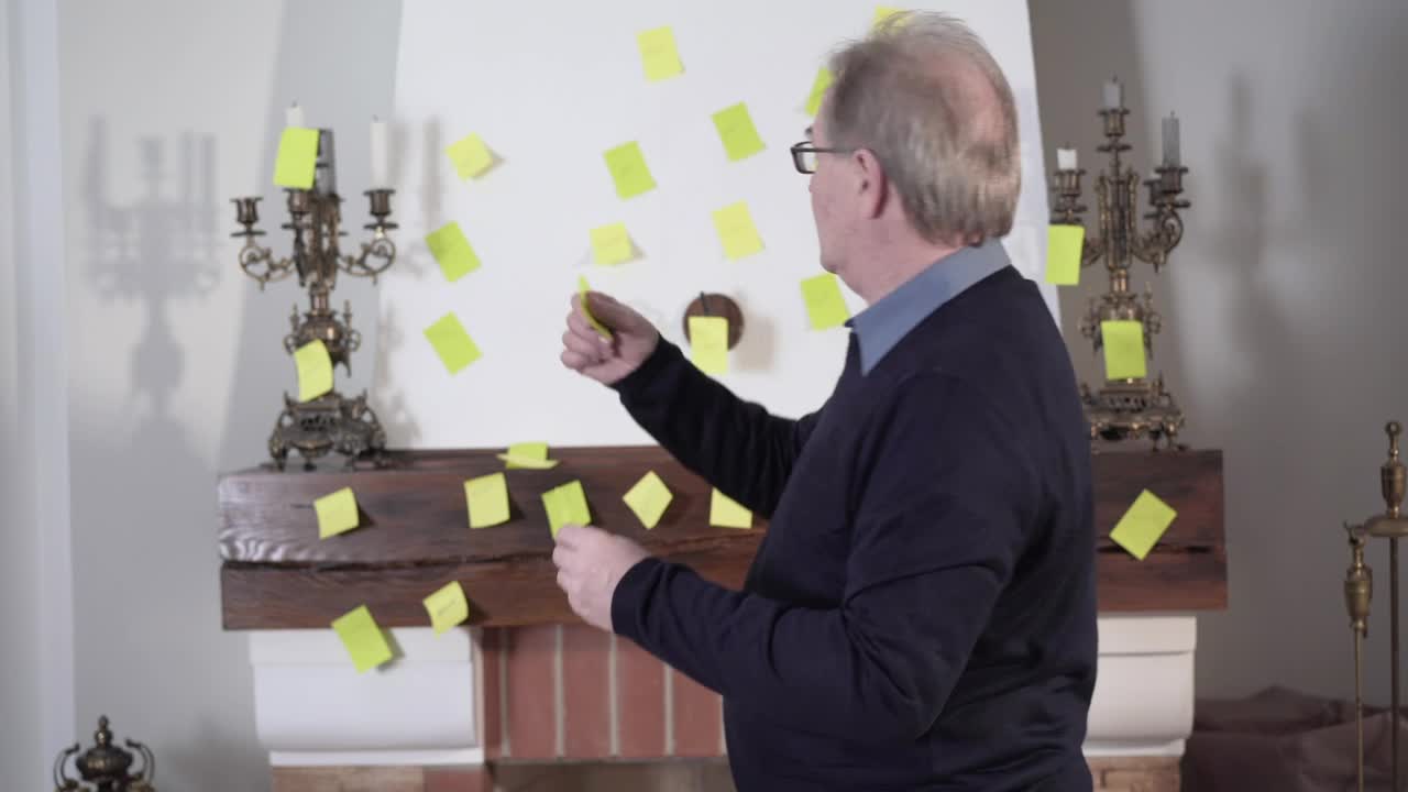 Stock Video Old Man Placing Notes On The Wall For His Memory Live Wallpaper