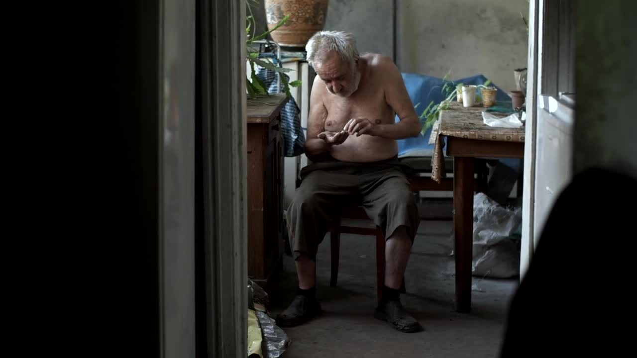 Stock Video Old Poor Hungry Man Counting Coins Live Wallpaper
