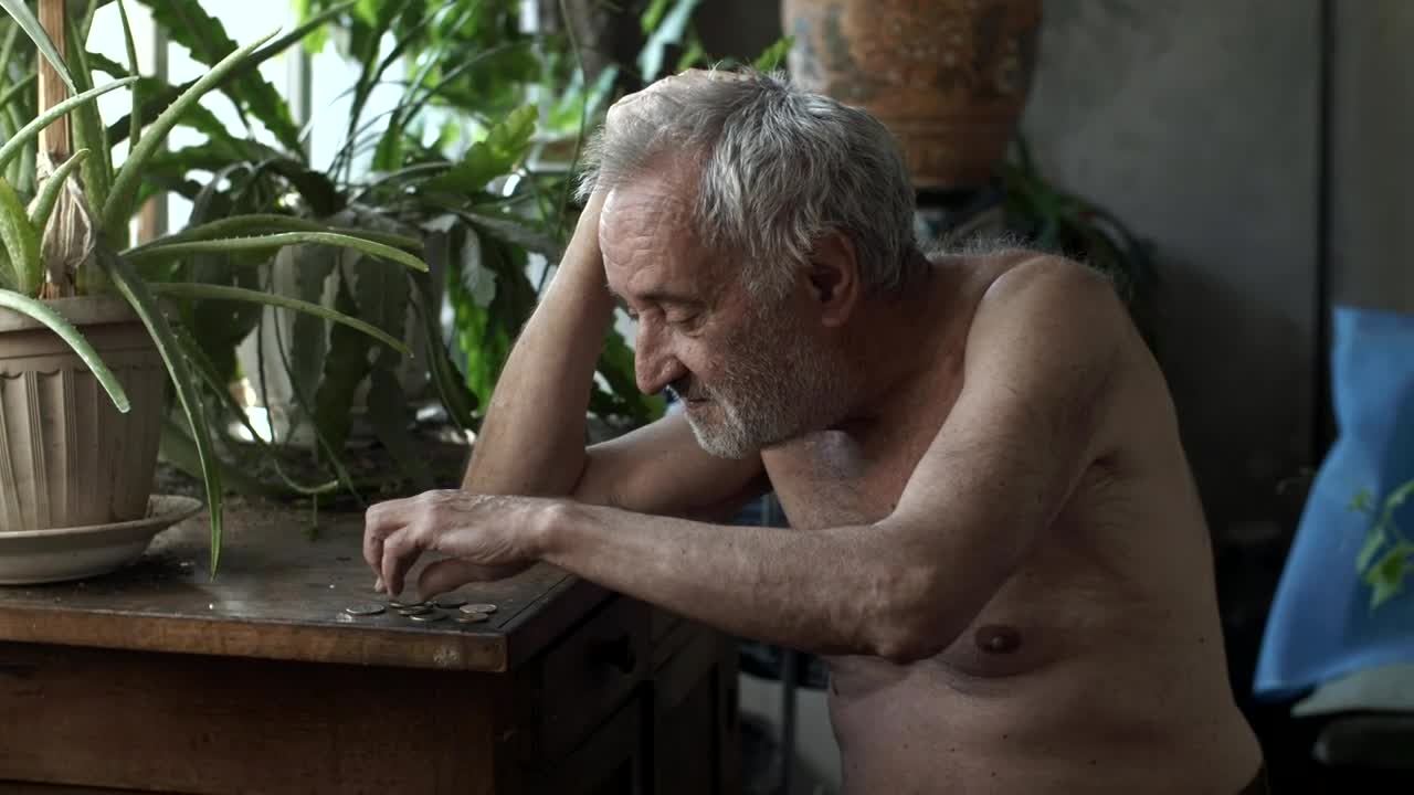 Stock Video Old Poor Man Counting Coins Live Wallpaper