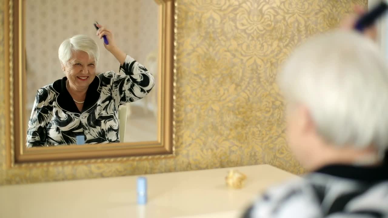 Stock Video Old Woman Combing Her Gray Hair Live Wallpaper