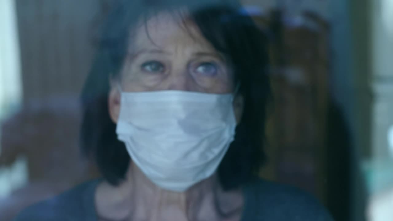 Stock Video Old Woman Looks With Concern Out The Window Live Wallpaper