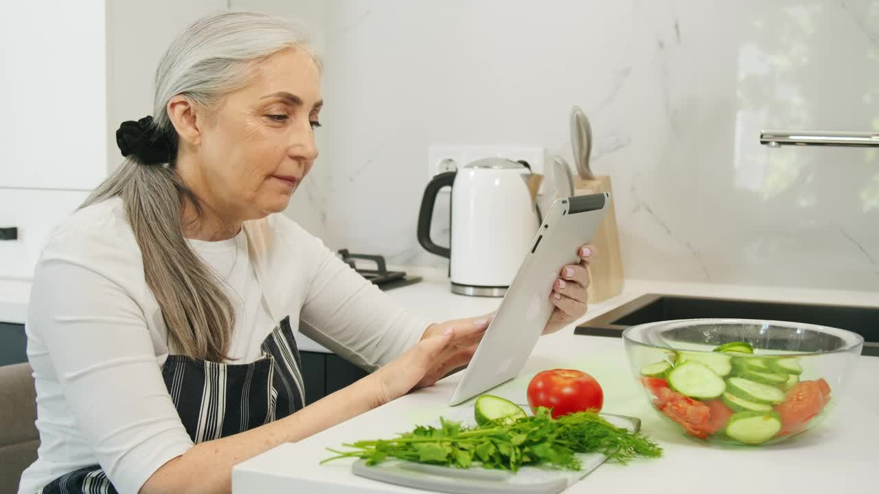 Stock Video Old Woman Searching For Healthy Recipes Live Wallpaper