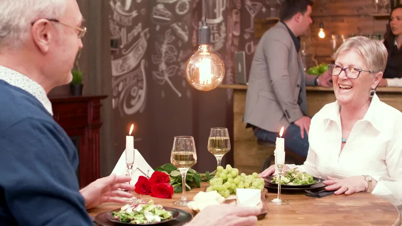 Stock Video Older Man Gives Woman Gift At Romantic Dinner Date Live Wallpaper