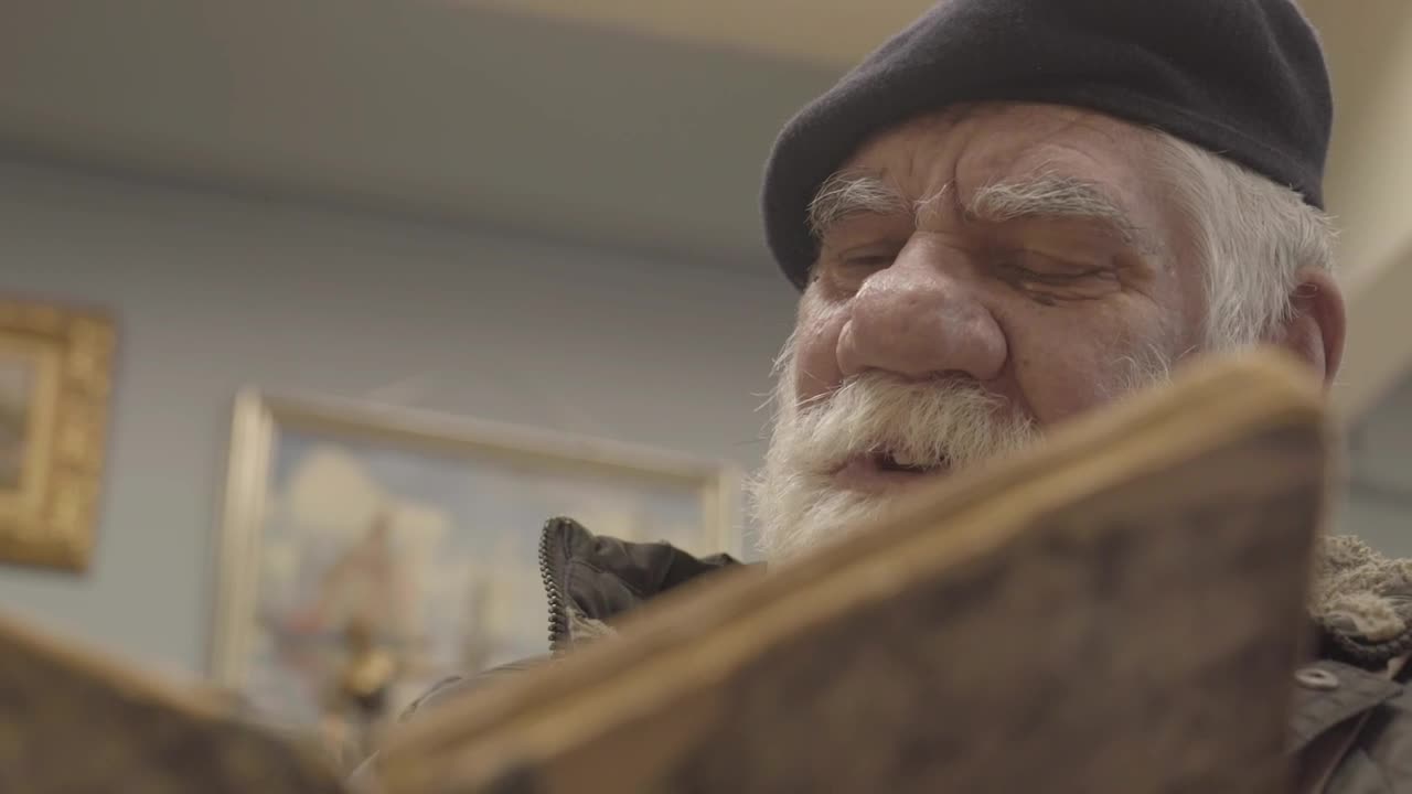 Stock Video Older Man Reading A Book Live Wallpaper