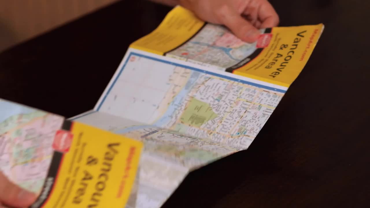 Stock Video Opening A Map On A Table Live Wallpaper