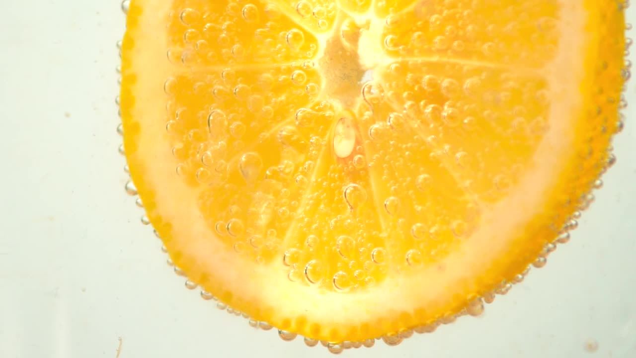 Stock Video Orange Slice Dipped In A Soda Live Wallpaper