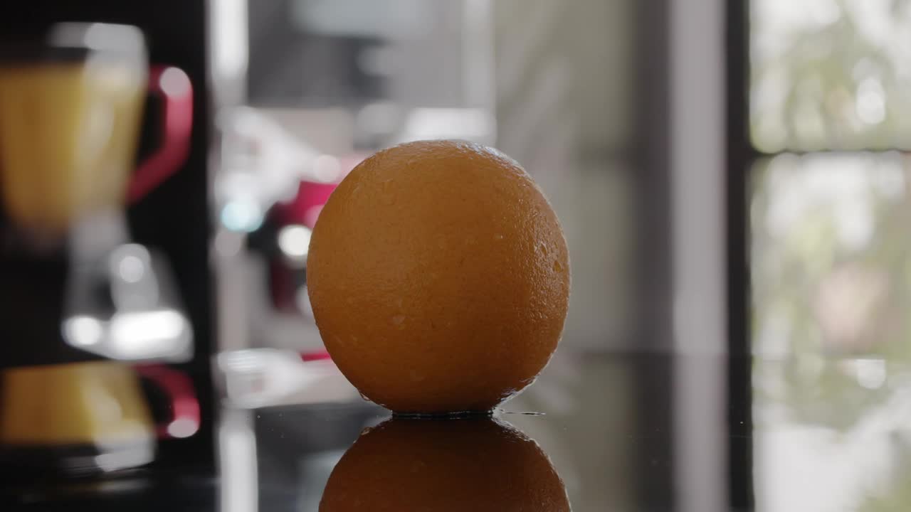 Stock Video Orange Spinning On A Table Live Wallpaper