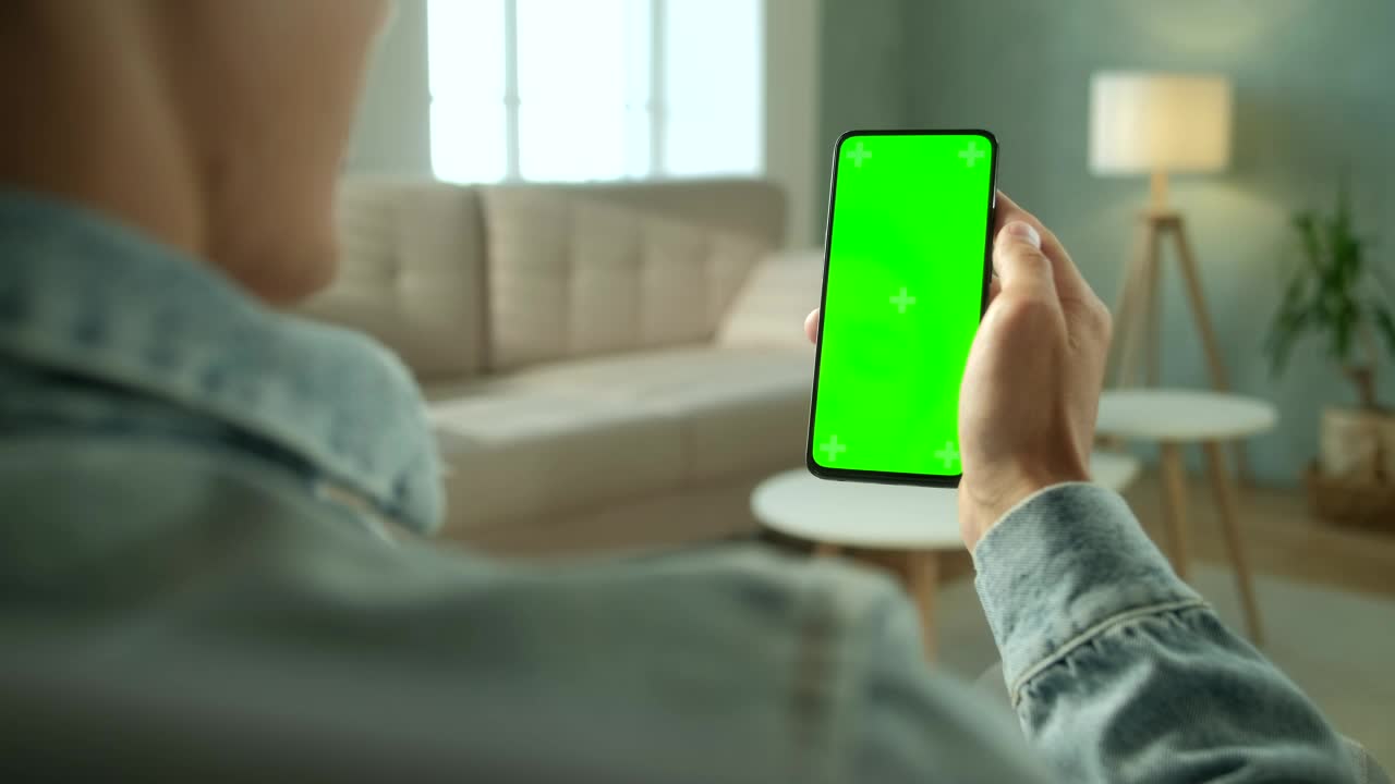 Stock Video Over Shoulder View Of A Man Holding A Green Screen Live Wallpaper