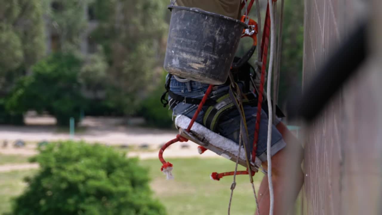 Stock Video Painter Repairing The External Wall Of A Building Live Wallpaper