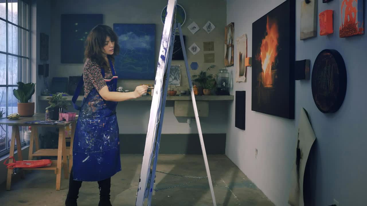 Stock Video Painter Working On A Painting In Her Workshop Live Wallpaper