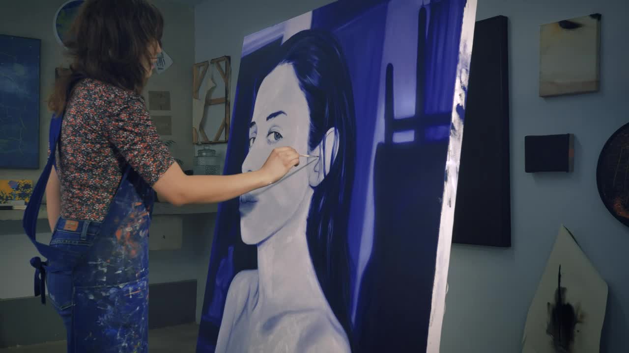 Stock Video Painter Working On A Portrait In Blue Tones Live Wallpaper