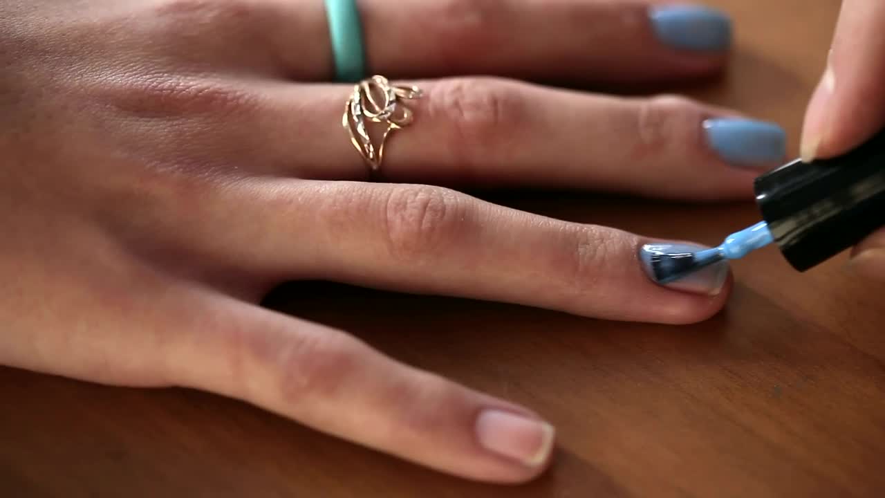 Stock Video Painting Blue Nails On Woman Hand Live Wallpaper