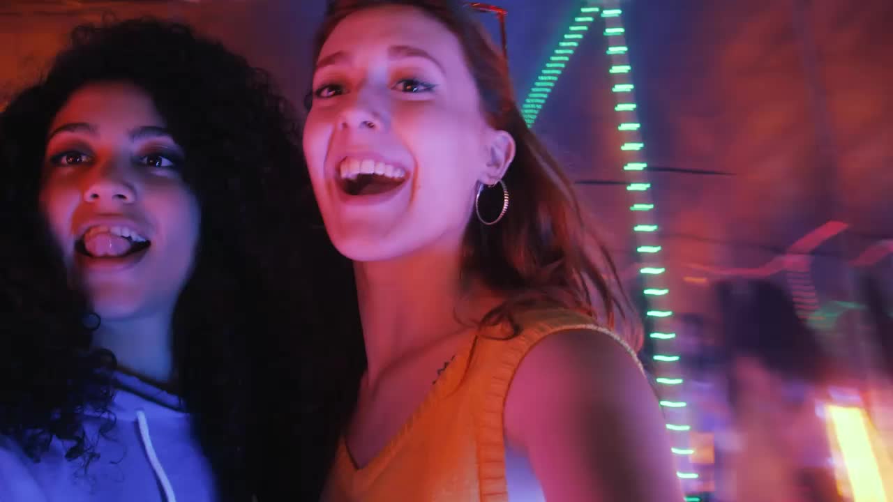 Stock Video Pair Of Female Friends Having Fun On A Night Out Live Wallpaper