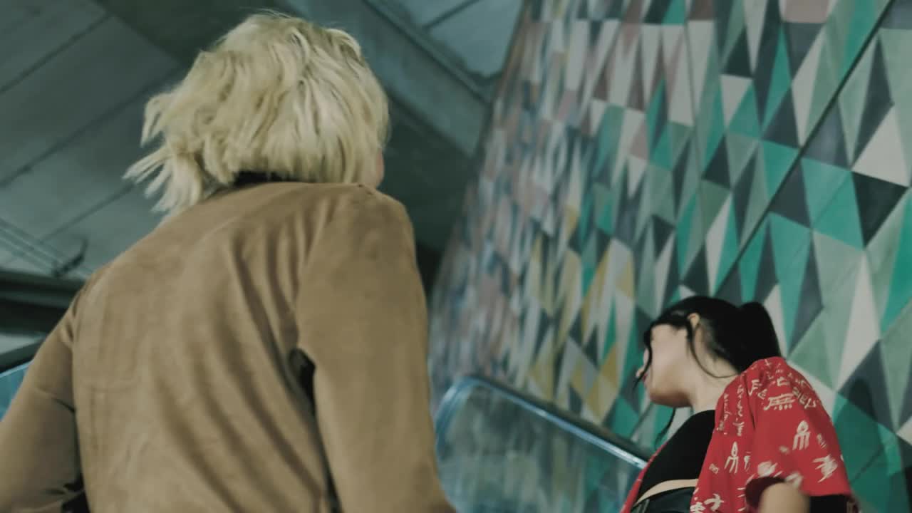 Stock Video Pair Of Girls On An Escalator Live Wallpaper