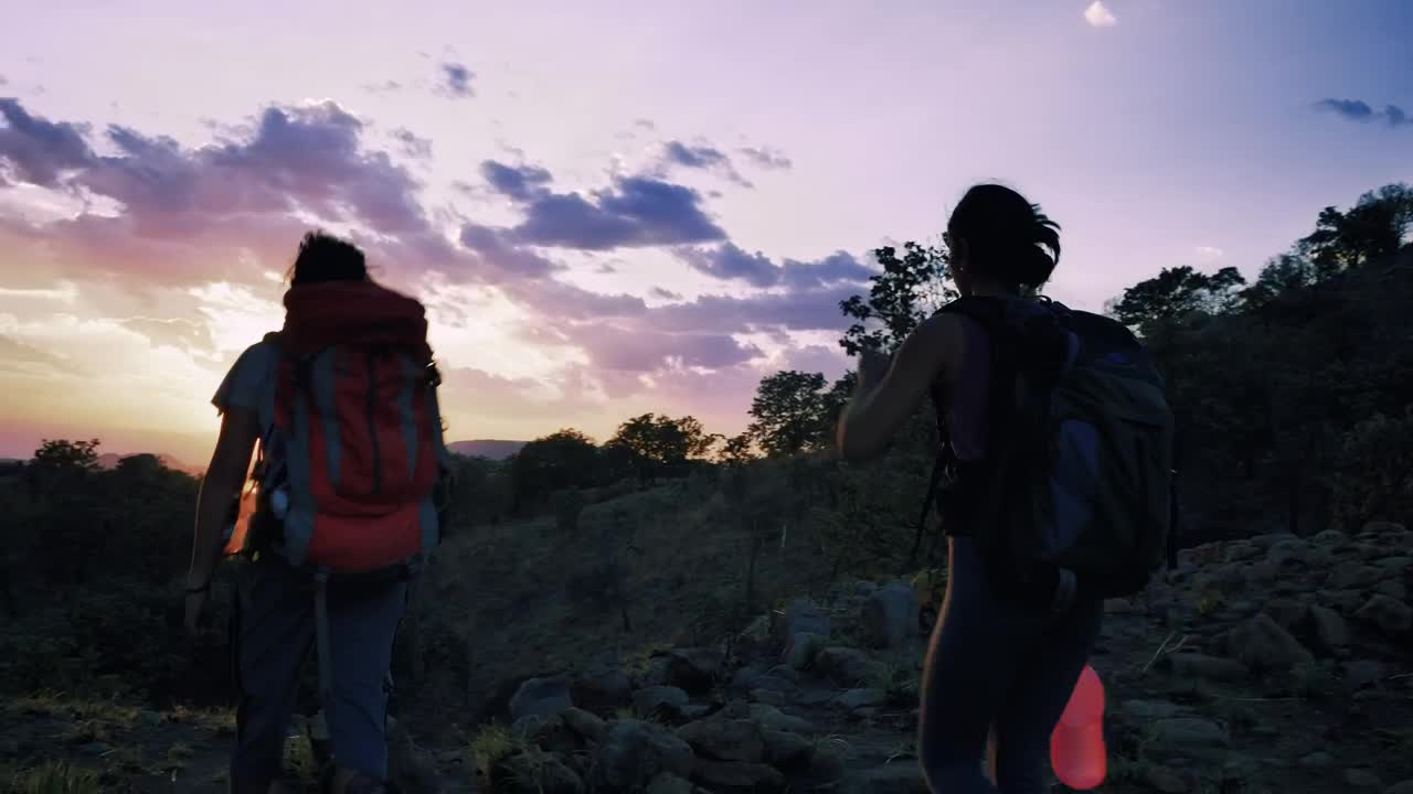 Stock Video Pair Of Mountaineers Leaving Through Nature At Sunset Live Wallpaper