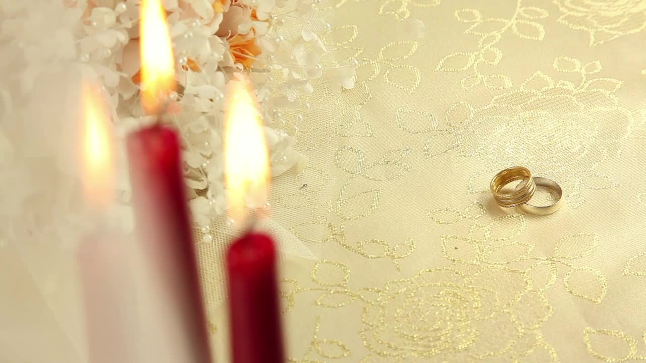 Stock Video Pair Of Rings Beside Plastic Flowers And Candles Live Wallpaper