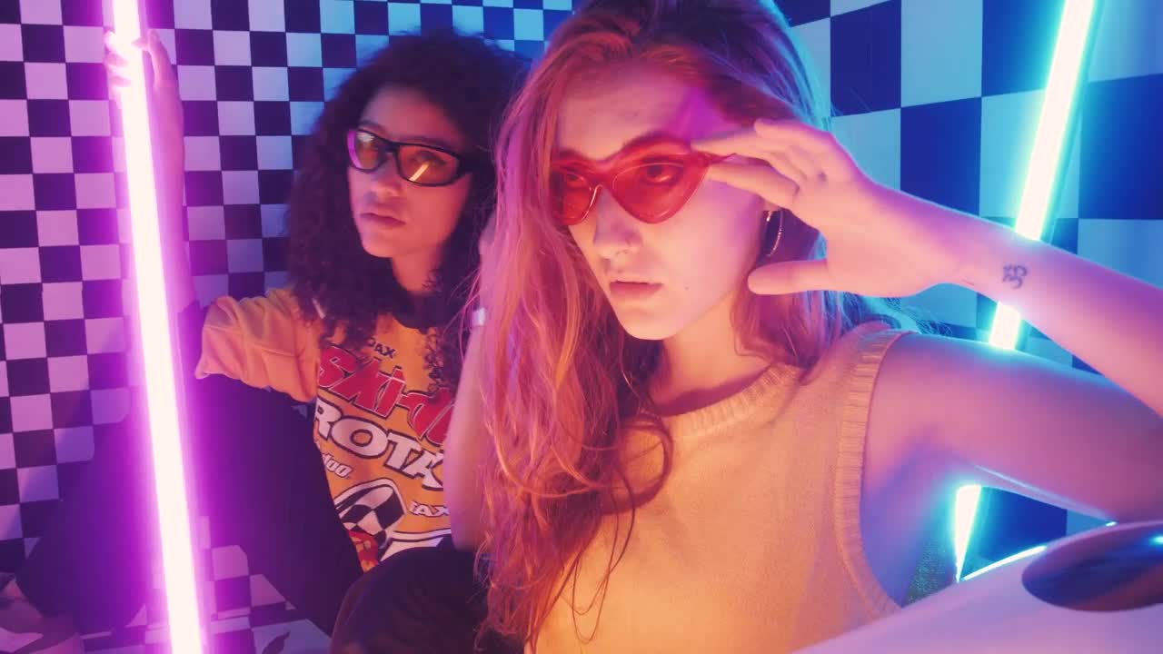 Stock Video Pair Of Stylish Girls Posing Captivatingly Live Wallpaper