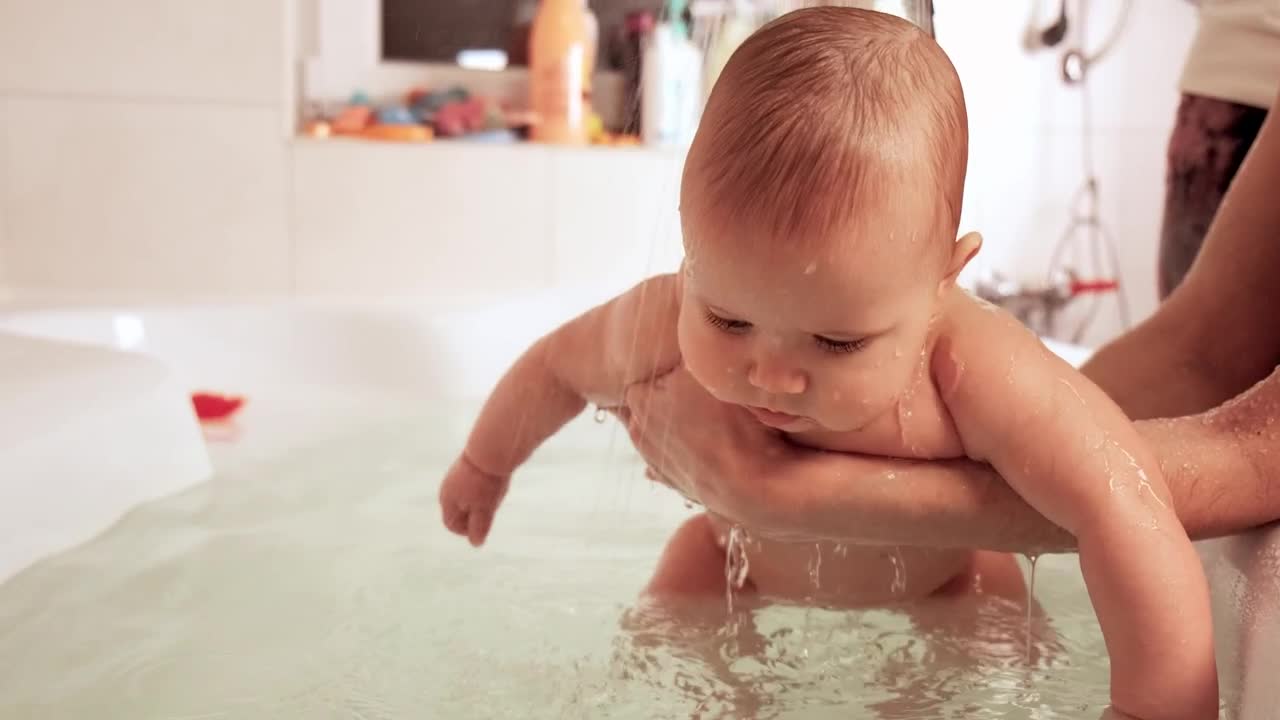 Stock Video Parents Bathing Their Baby In The Tub Live Wallpaper