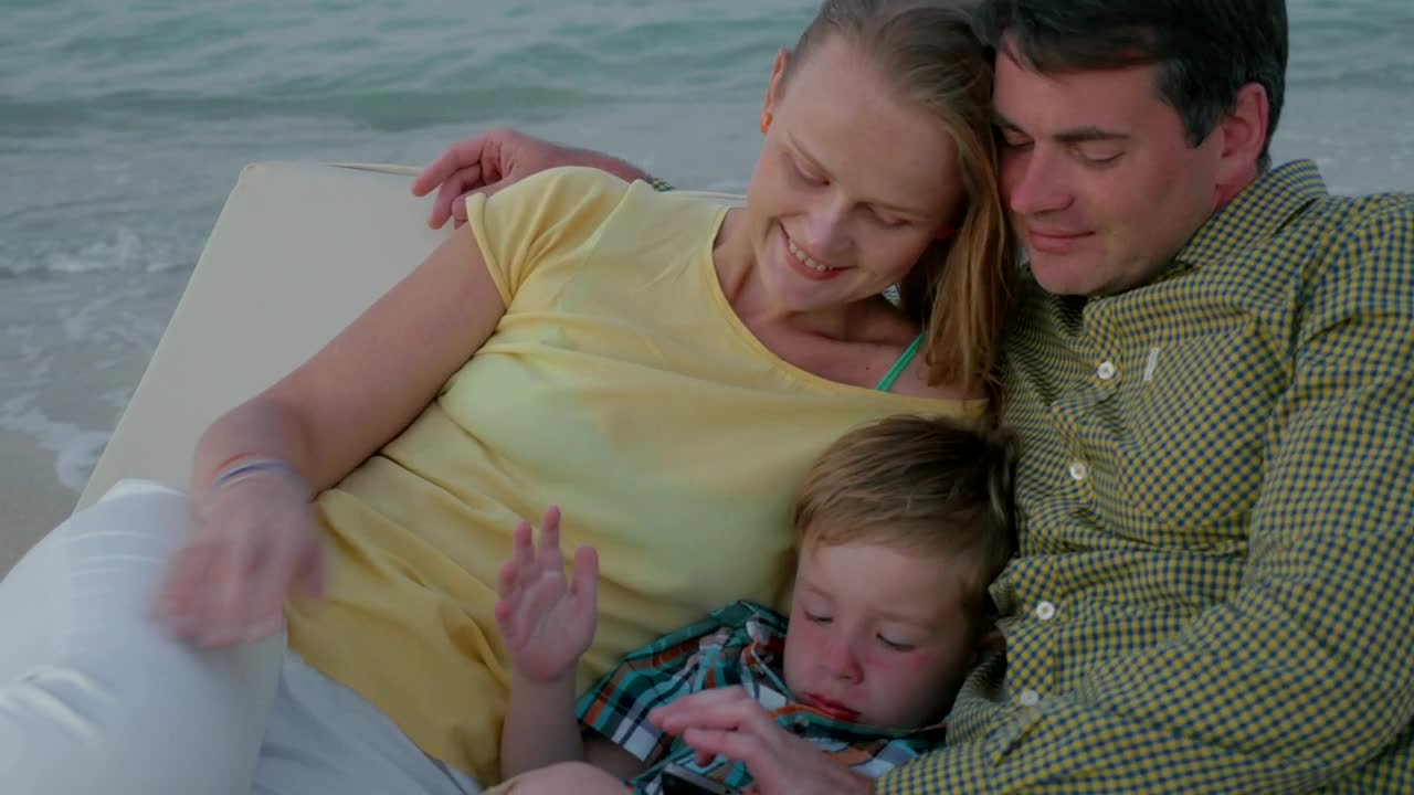 Stock Video Parents Laying With Their Tired Child Live Wallpaper