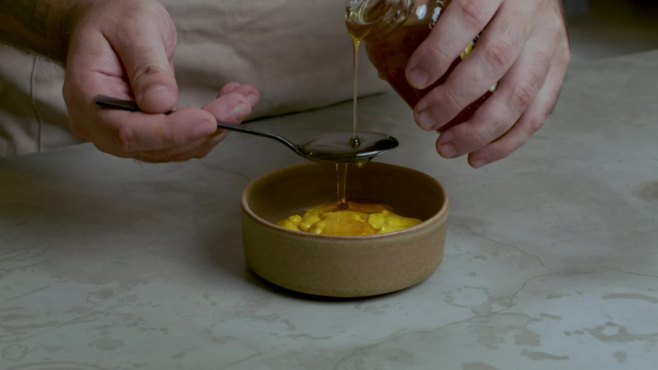Stock Video Pastry Chef Adding Honey To A Mixture Live Wallpaper