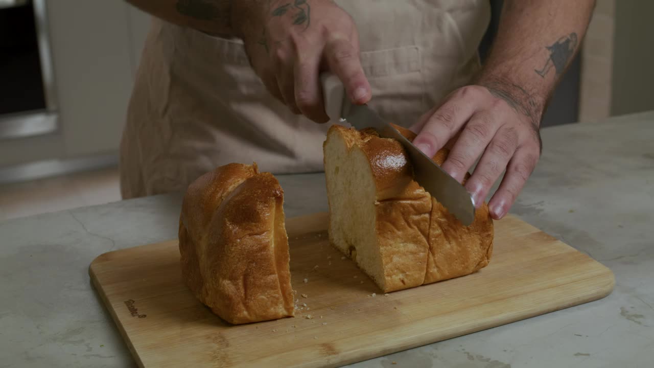 Stock Video Pastry Chef Cutting A Loaf Into Slices Live Wallpaper