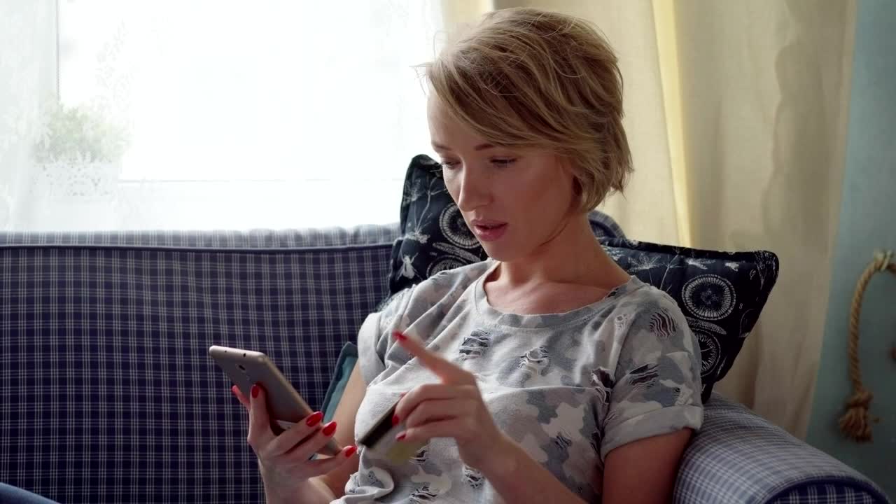 Stock Video Paying On Her Phone Using A Credit Card Live Wallpaper
