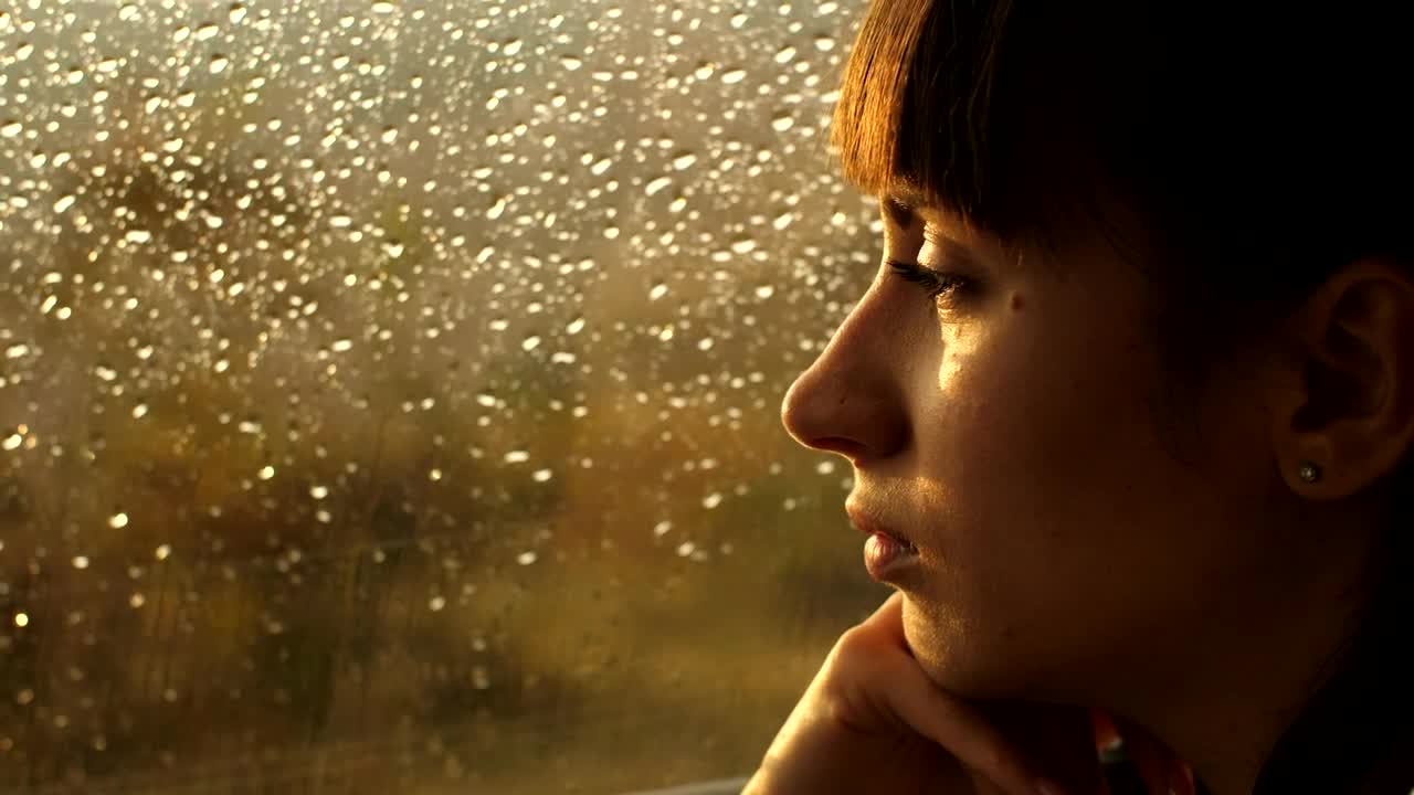 Stock Video Pensive Woman Looking Out Of A Window On A Rainy Live Wallpaper