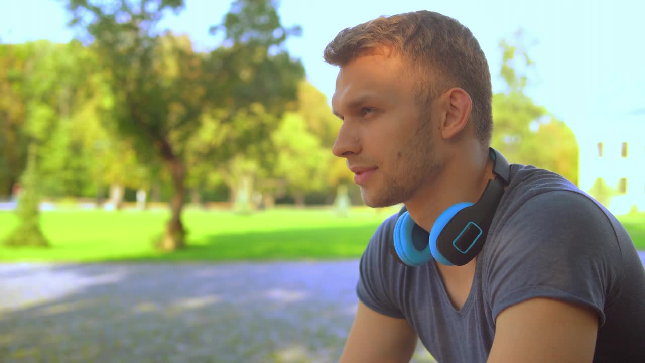 Stock Video Pensive Young Man Listening To Music On His Headphones Live Wallpaper
