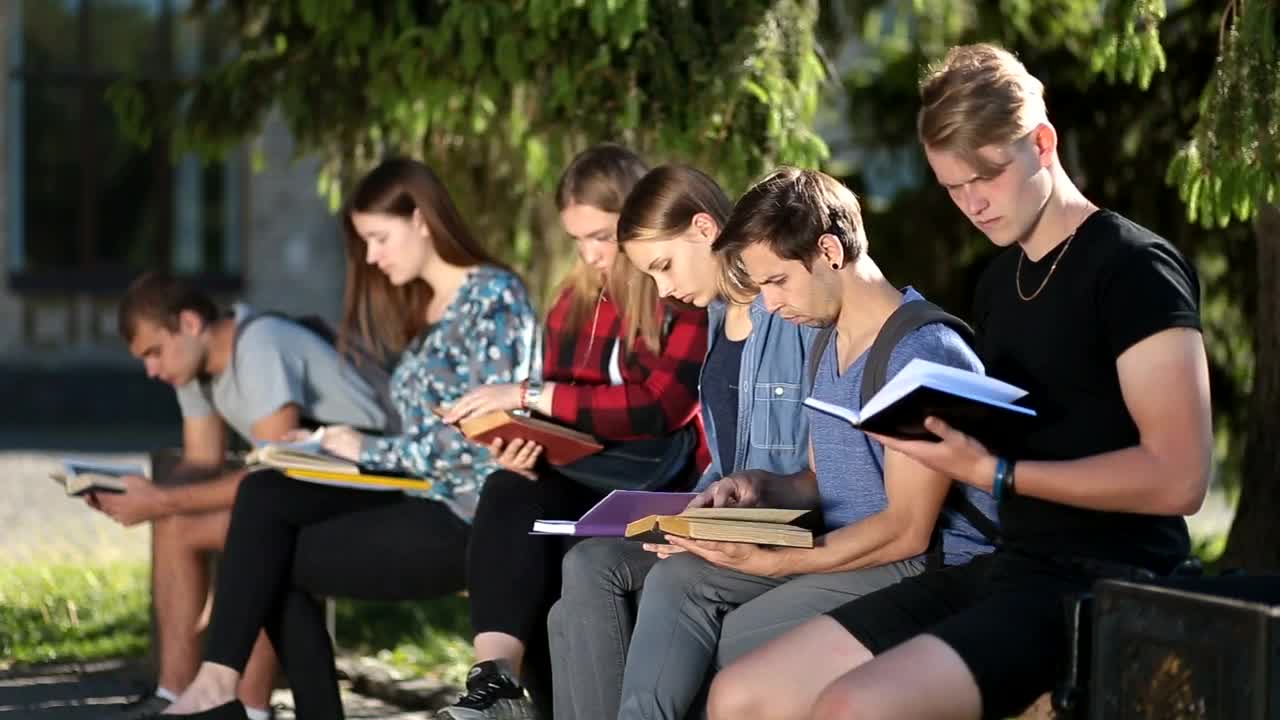 Stock Video People In A Garden Studying With Books In Hand Live Wallpaper