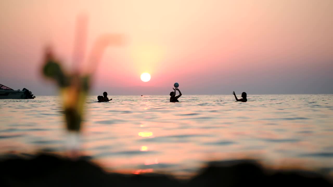 Stock Video People Playing Ball In The Ocean At Sunset Live Wallpaper