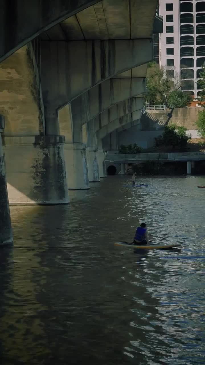 Stock Video People Rowing In A River In The City Live Wallpaper