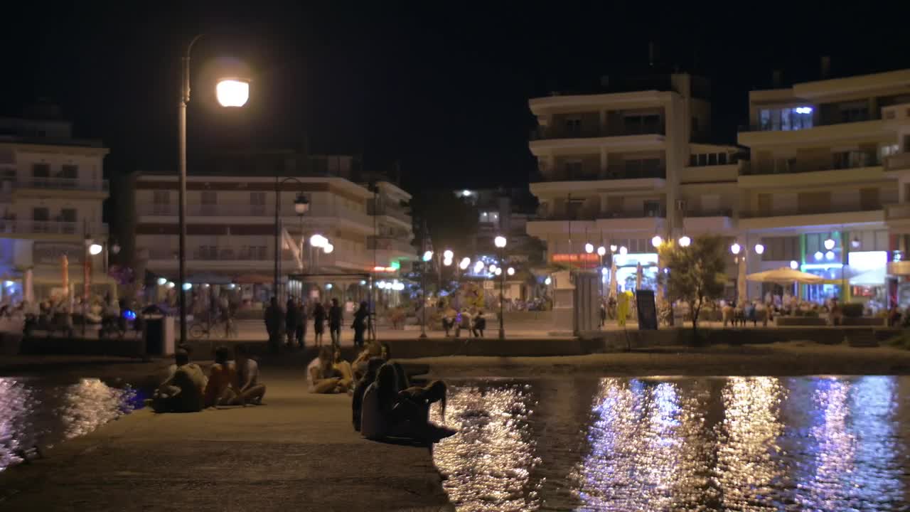 Stock Video People Sitting On A City Pier Live Wallpaper