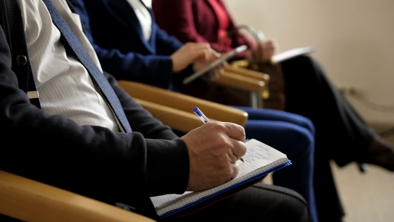 Stock Video People Taking Notes During A Meeting Live Wallpaper