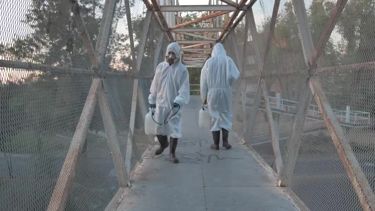 Stock Video People With Masks Sanitizing A Pedestrian Bridge Live Wallpaper