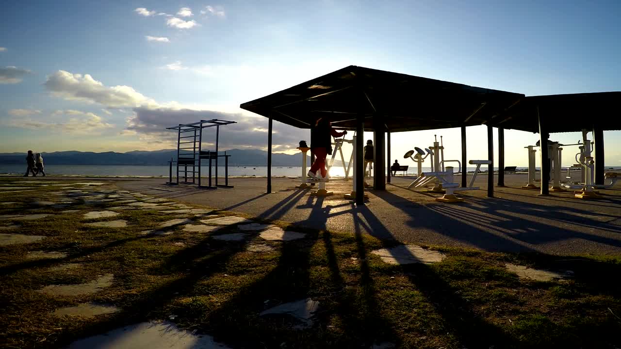 Stock Video People Working Out On The Beach At An Outdoor Gym Live Wallpaper