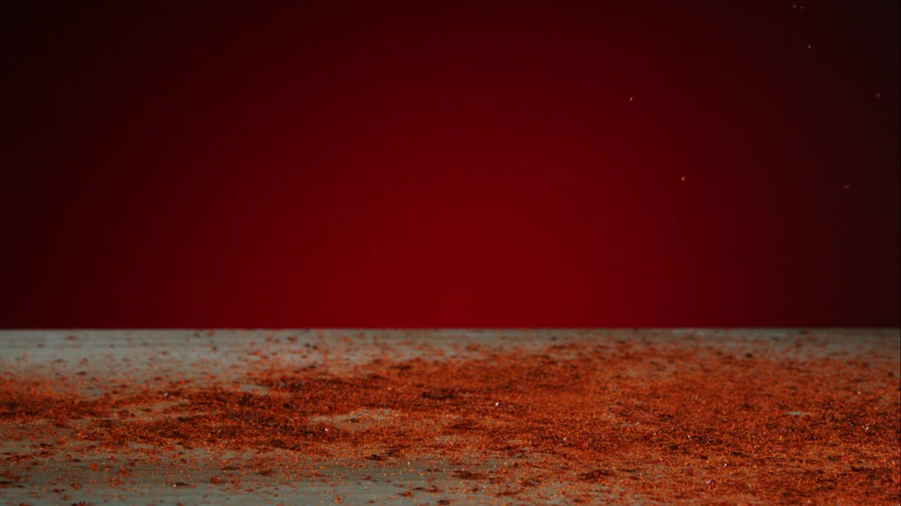 Stock Video Peppers And Red Powder Falling To The Table Live Wallpaper