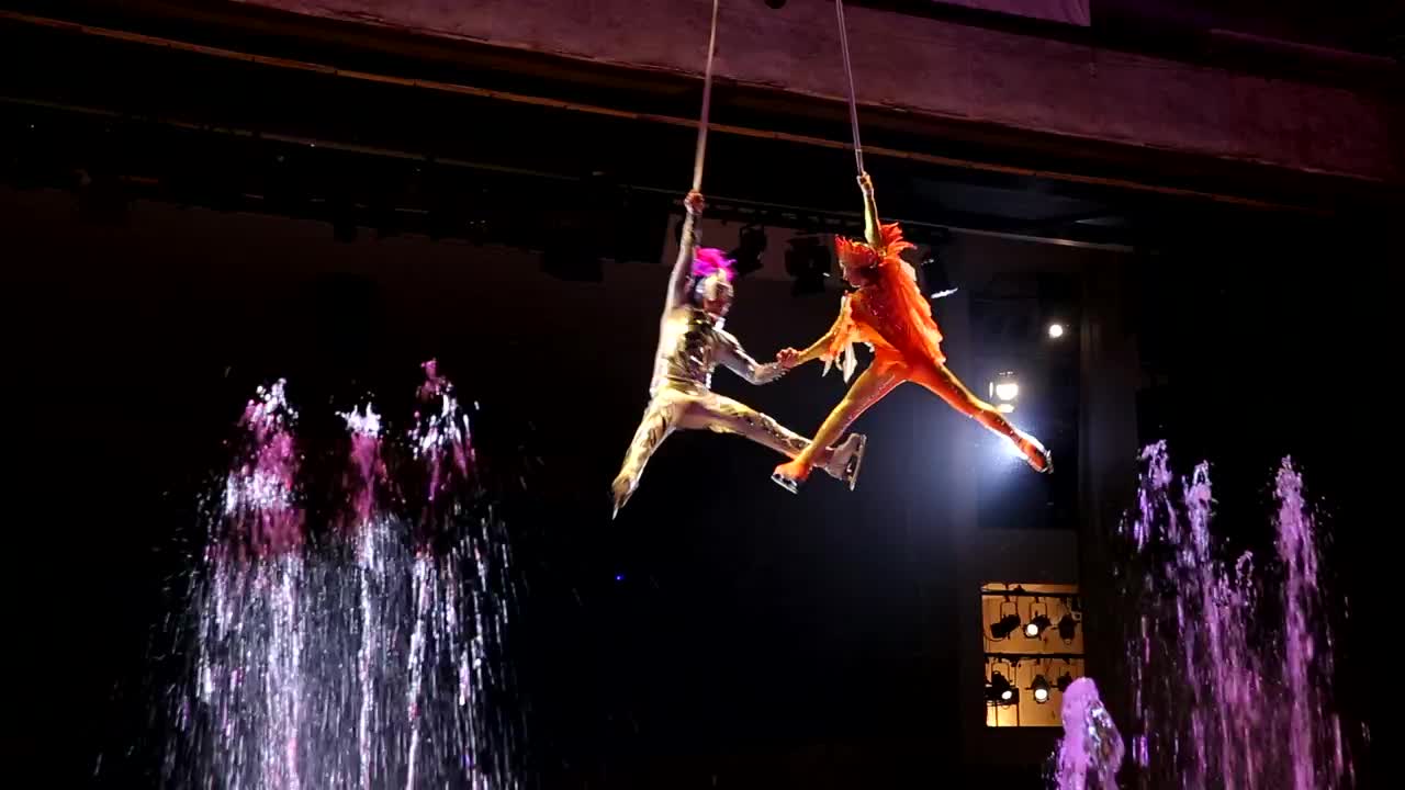 Stock Video Performer Spinning Above Bright Fountains Live Wallpaper