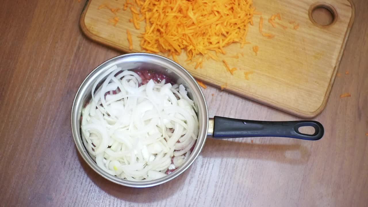 Stock Video Person Adding Grated Carrot To A Recipe Live Wallpaper