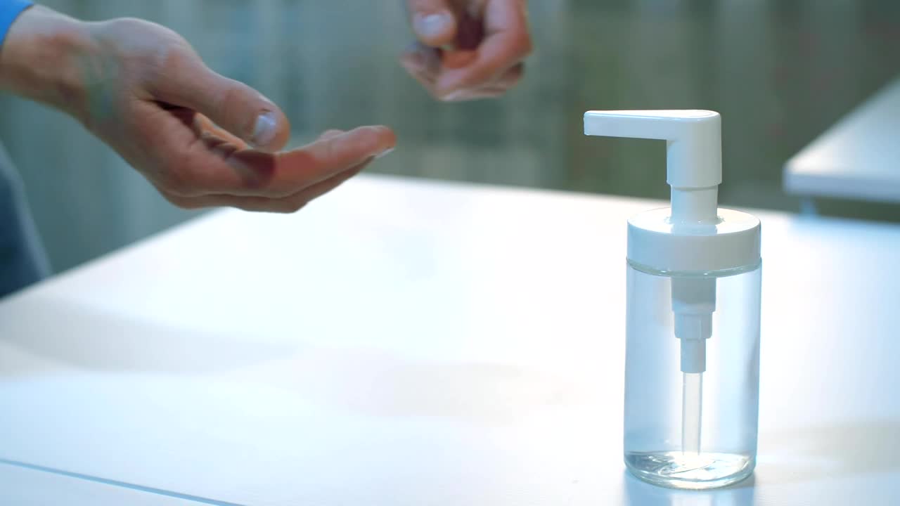 Stock Video Person Applying Alcohol Gel On Their Hands Live Wallpaper