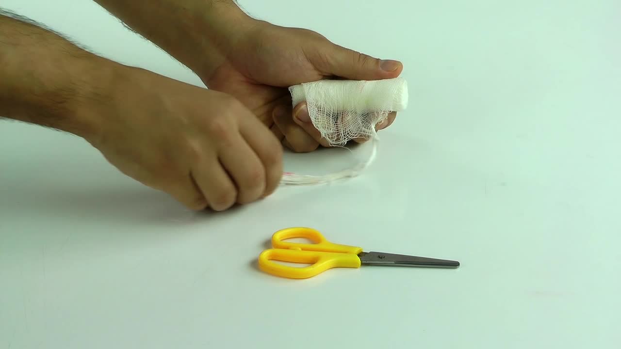 Stock Video Person Bandaging Himself The Hurt Hand Live Wallpaper