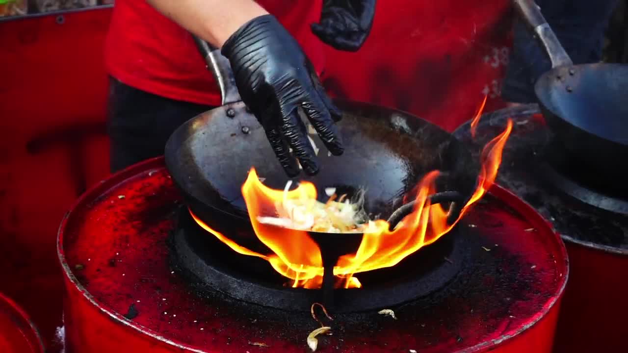 Stock Video Person Cooking In A Wok Pan With High Flame Live Wallpaper