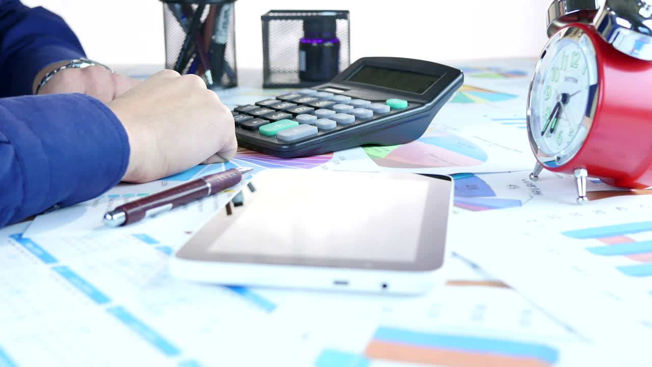 Stock Video Person Corroborating Data From Some Graphs On Paper Live Wallpaper