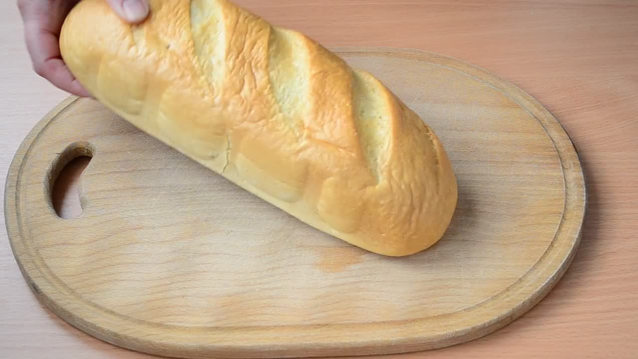 Stock Video Person Cutting Bread On A Board Live Wallpaper