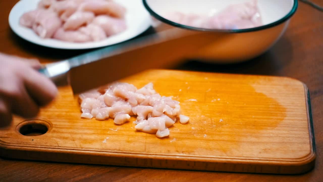 Stock Video Person Cutting Meat Into Small Pieces Live Wallpaper