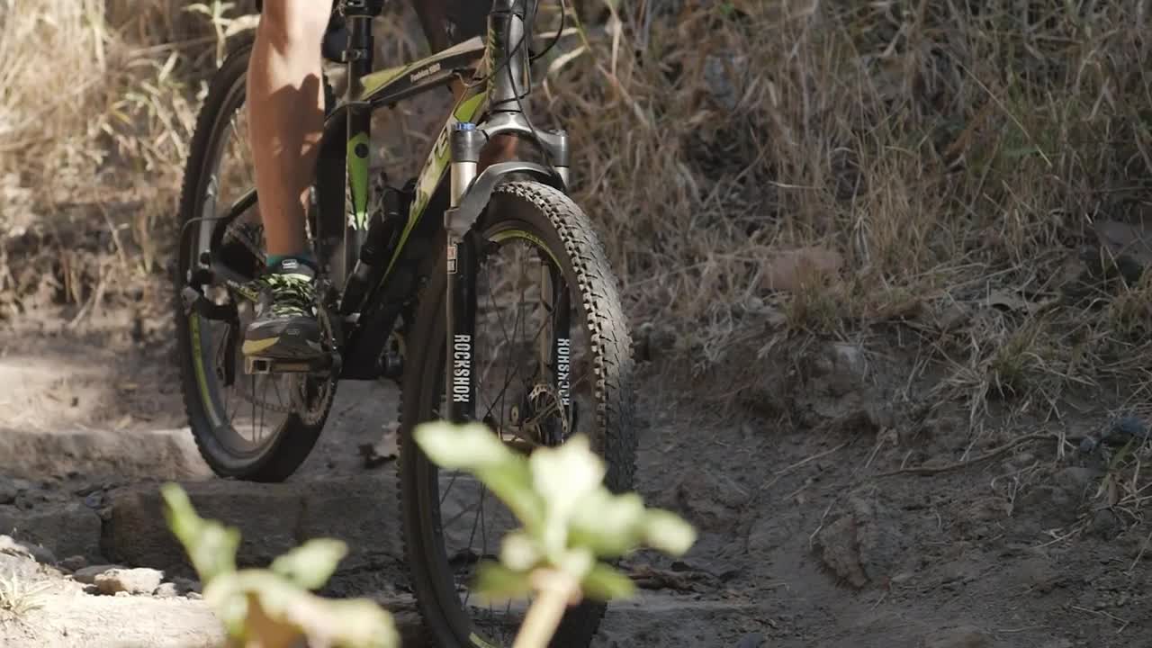 Stock Video Person Cycling Down A Rocky Slope Live Wallpaper