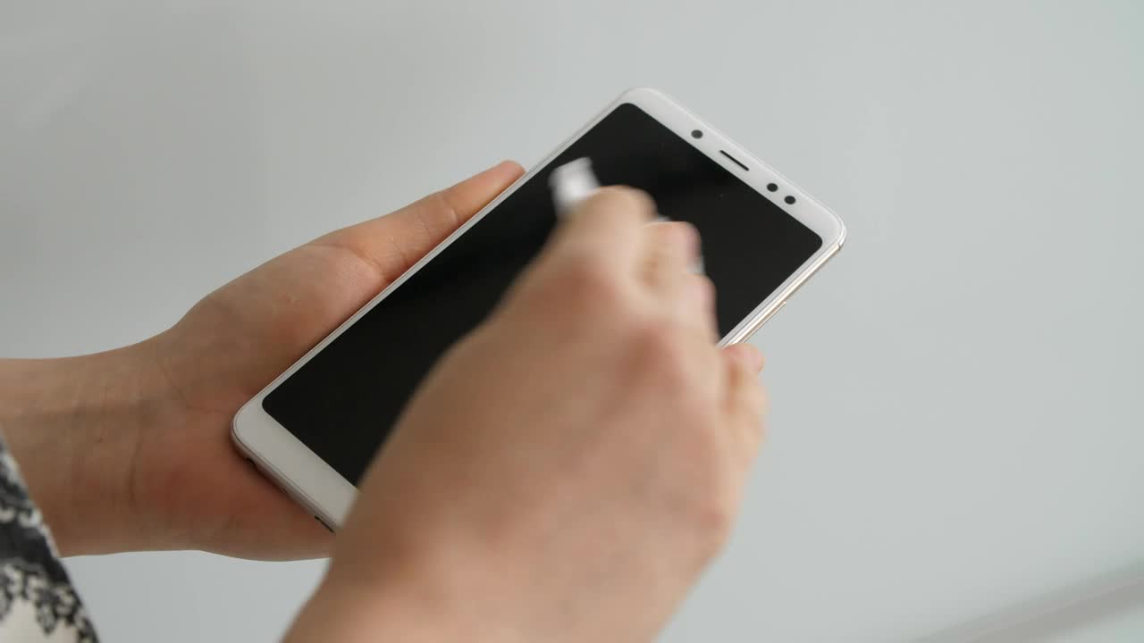 Stock Video Person Disinfecting His Cell Phone Live Wallpaper