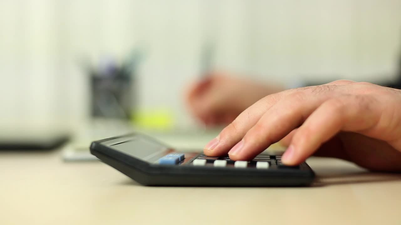Stock Video Person Doing Calculations With A Calculator Live Wallpaper