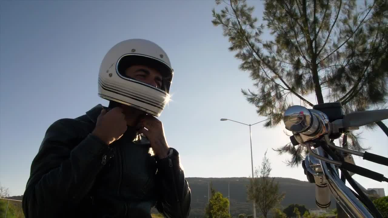 Stock Video Person Fastens Helmet While Atop A Motorcycle Live Wallpaper