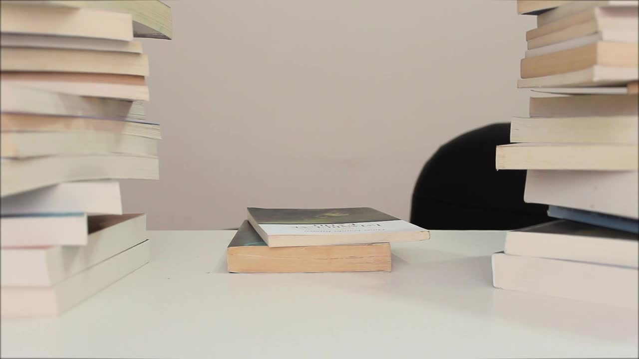 Video Stock Person Sits Down To Read Surrounded By Many Books Live Wallpaper Free