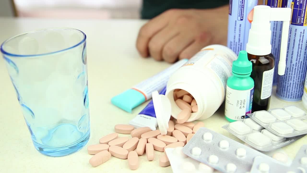 Video Stock Person Taking A Pill Among Other Drugs Live Wallpaper Free